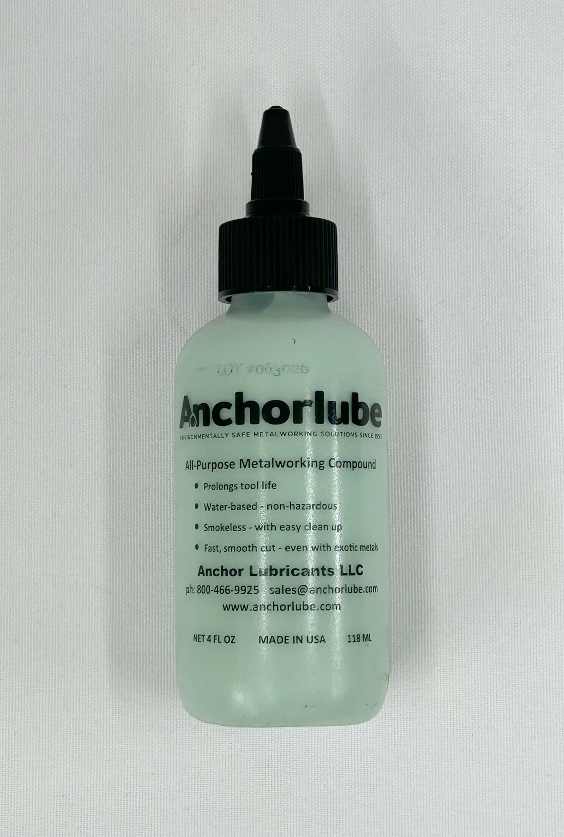 A bottle of Anchorlube All Purpose Metalworking Compound with a black cap and a pale green translucent bottle, shown against a white background.