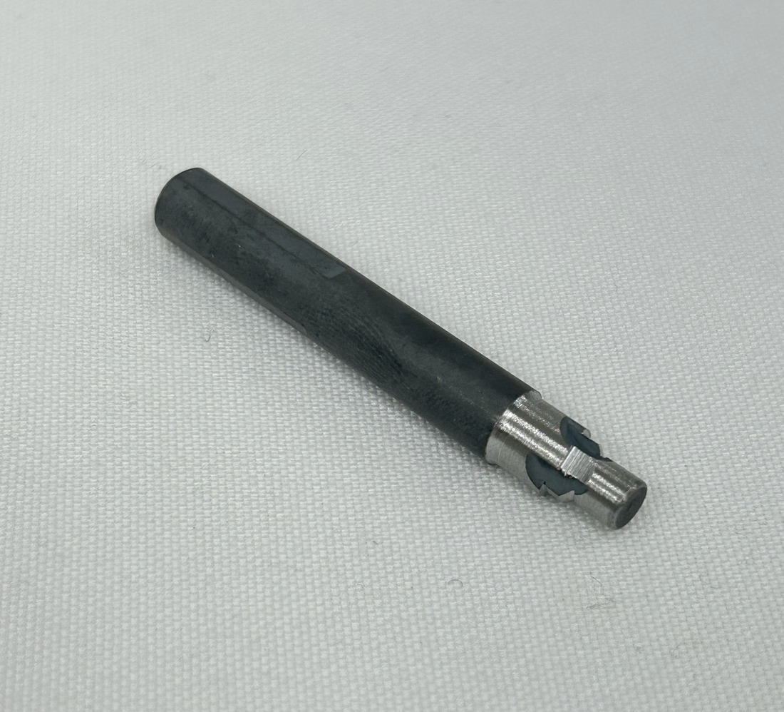 A black metal socket wrench bit with a slotted center, shown vertically on a textured white background.