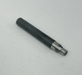 A small cylindrical metal tool bit with a black coated body and a silver exposed cutting section, photographed diagonally on a white textured fabric background.