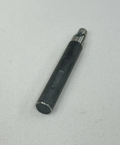 A black cylindrical metal tool or pen-like accessory with a silver tip, placed diagonally on a textured white fabric background.