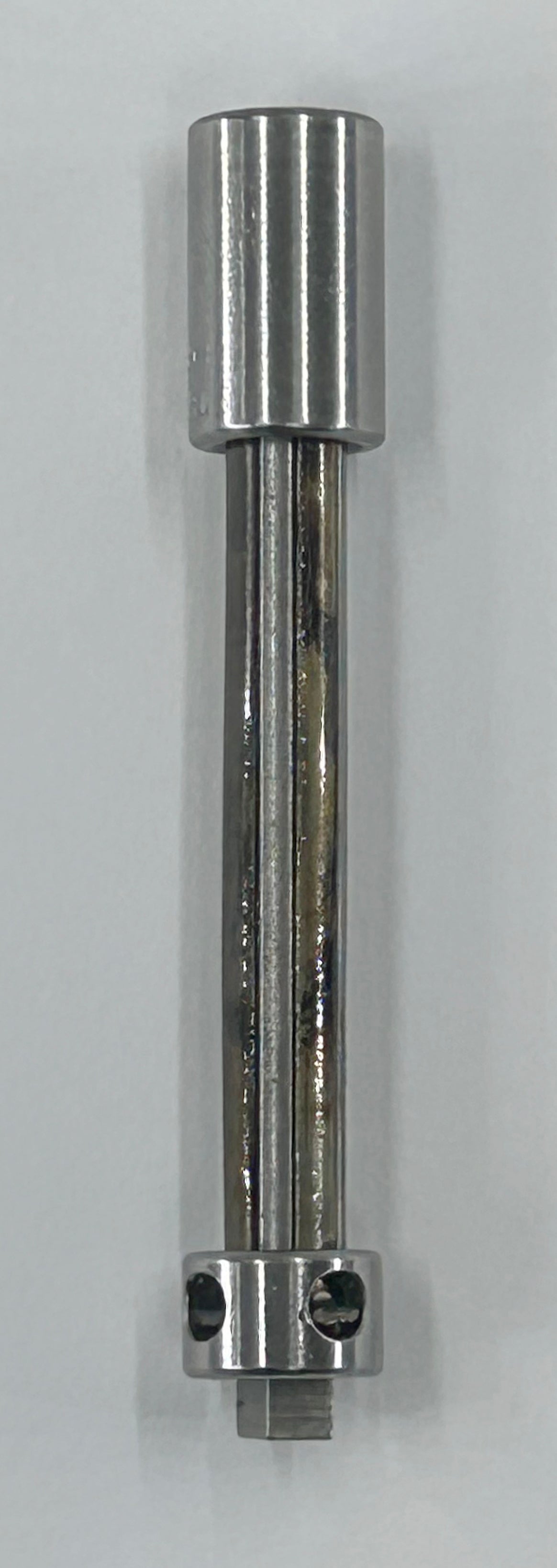 A polished metal cylindrical tool or hardware component with a flanged base, shown vertically against a plain light gray background.
